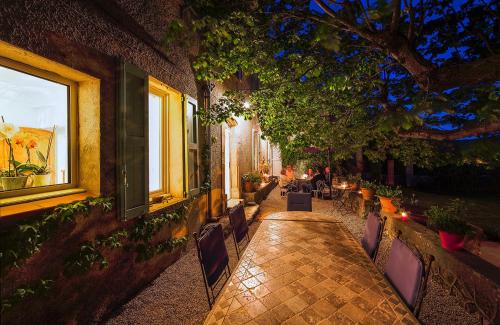 a restaurant with a long table and chairs at La Grande Maison De Nans in Nans-les-Pins