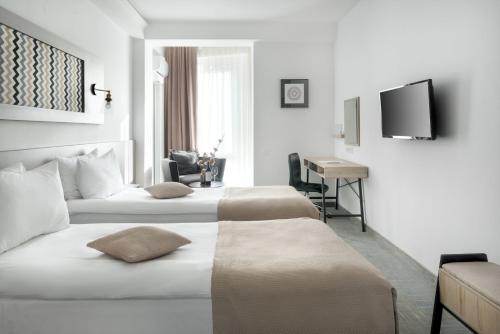 Postel nebo postele na pokoji v ubytování Thomas Albert Hotel