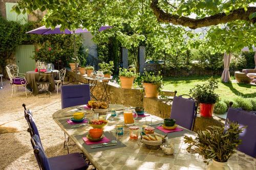 a table with food on it in a garden at La Grande Maison De Nans in Nans-les-Pins