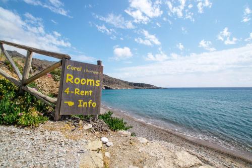 a sign on the side of a beach near the water at Coral Front Beach in Káto Zákros