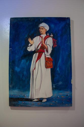 a painting of a woman on a wall at Auberge oued dades in Boumalne