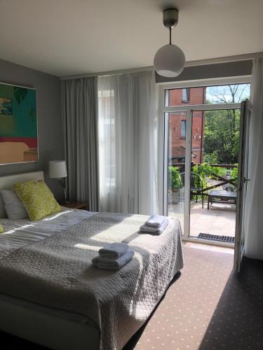 a bedroom with a bed with two towels on it at Dom Młynarza in Żukczyn