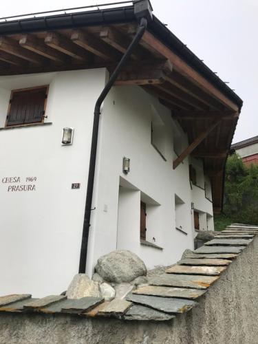 a white building with a group of windows at Comfort and sunshine in Celerina Chesa Prasura in Celerina