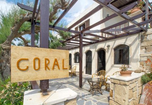 a sign that reads coral in front of a house at Coral Front Beach in Káto Zákros