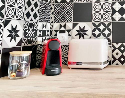 a kitchen counter with a toaster and a toaster at Bleu Soleil Rochefort 3 étoiles in Rochefort