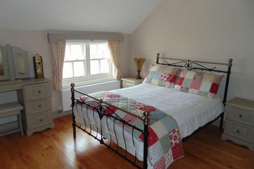 A bed or beds in a room at Cecil's Cottage, Ballynary, Buncrana by Wild Atlantic Wanderer
