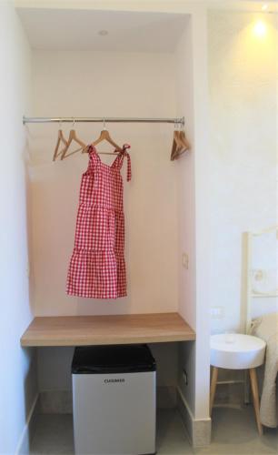 a room with a shelf with a red dress on it at Hotel - Giardino Marchese D'Altavilla in Tropea