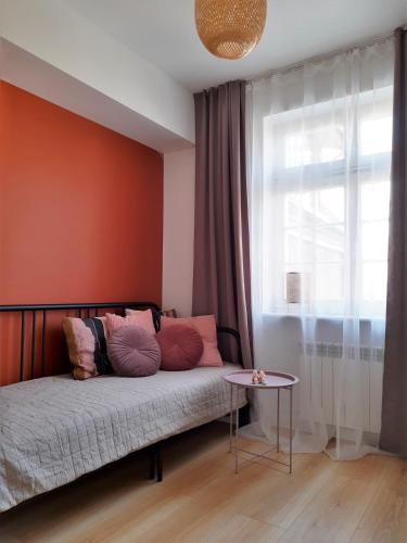 a bedroom with a bed and a window and a table at P79 in Olsztyn