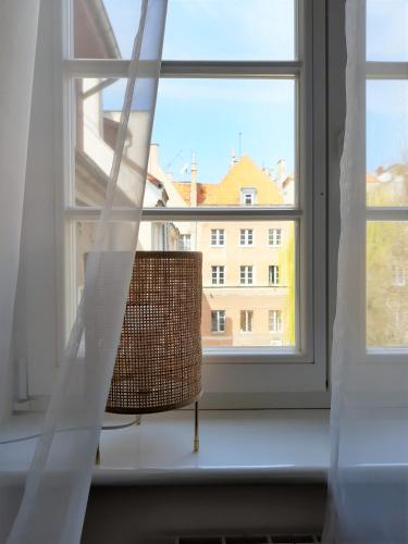 a wicker chair sitting in front of a window at P79 in Olsztyn