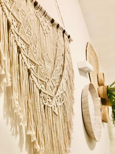 a white rope hanging on a wall with a mirror at L Antico Forno Bari Centro Storico in Bari