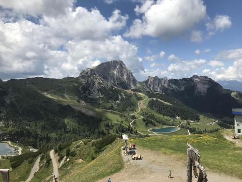 a group of people sitting on a hill in the mountains at Apartment Sophia in Sonnenalpe Nassfeld