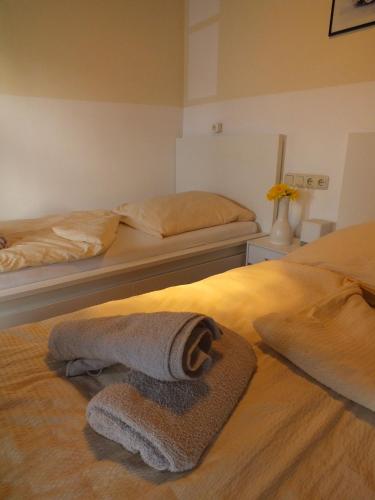 a hotel room with two beds with towels on the bed at TrattoriaDonLillo Fewo in Idstein