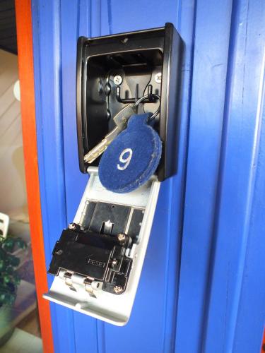 a locker with a blue padlock hanging from a door at TrattoriaDonLillo Fewo in Idstein