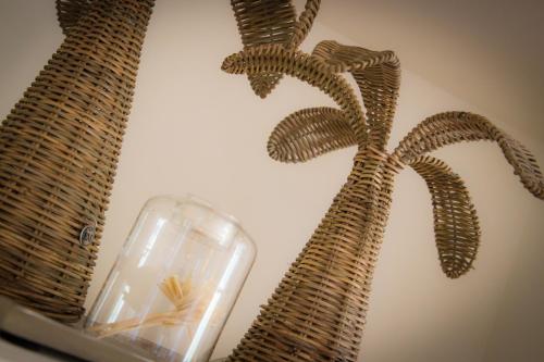 a glass vase with a palm tree on a wall at Hacienda el Tarajal in Priego de Córdoba
