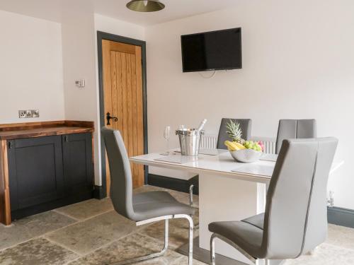 a dining room with a white table and chairs at 6 Lock View in Skipton