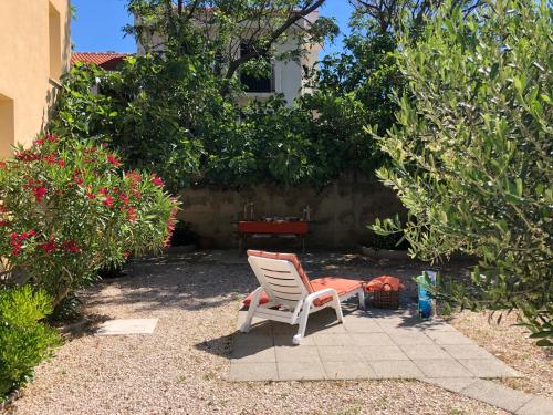 a chair sitting in the middle of a yard at Villa Dora in Pag