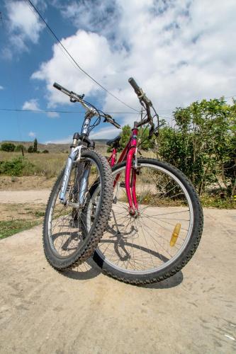 a red bike parked on a dirt road at Coral Front Beach in Káto Zákros