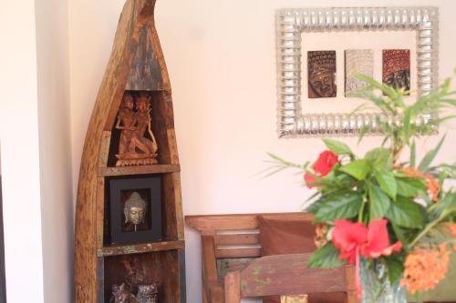 a room with a mirror and a vase with a plant at Jukung Villas Kuta in Kuta