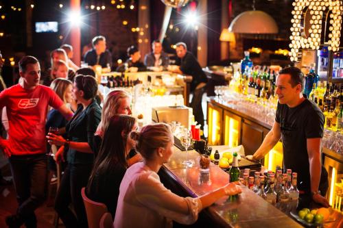 a group of people sitting at a bar at pentahotel Wiesbaden in Wiesbaden
