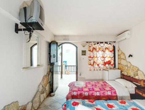 a bedroom with two beds and a window at Coral Front Beach in Kato Zakros