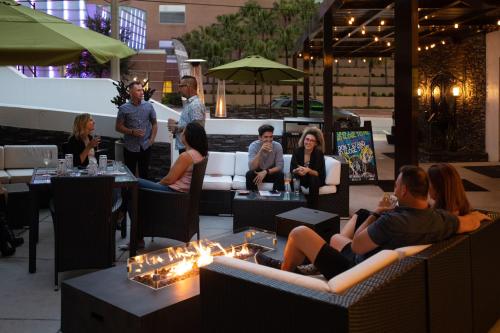 a group of people sitting in chairs in a restaurant at The Delaney Hotel in Orlando