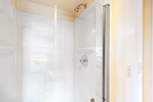 a shower with a glass door in a bathroom at Summit 2-105 in Granby