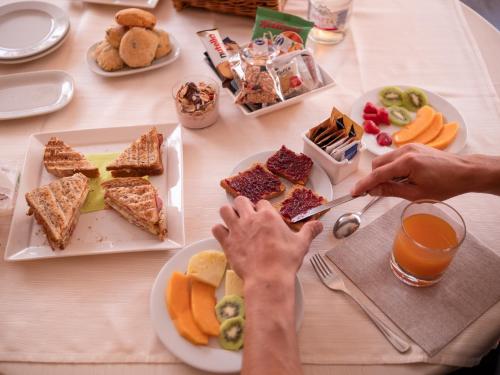 a table with a bunch of food on it at Hotel Del Riale in Parabiago