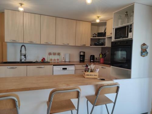 a kitchen with wooden cabinets and a wooden counter top at Maison avec vue in Les-Pennes-Mirabeau