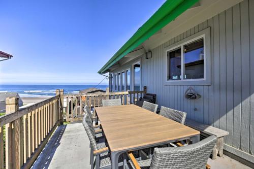 a table and chairs on a deck with the beach at Walk to Beach Oregon Coast Escape with Hot Tub! in Lincoln City