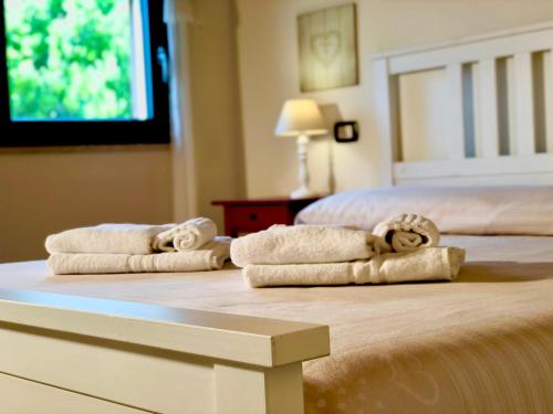 two towels are sitting on top of a bed at Cuore Della Valle in Cefalù