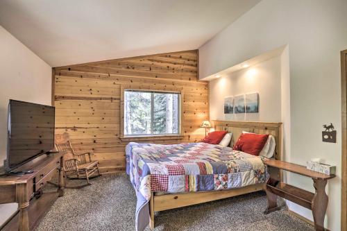 a bedroom with a bed and a wooden wall at Modern Mountain Chalet Near Donner Lake! in Truckee