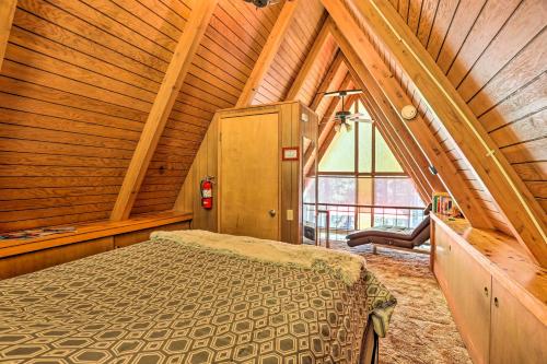 a bedroom with a bed in a wooden ceiling at Running Springs A-Frame with Deck and Mtn Views! in Running Springs