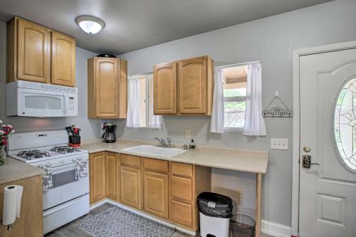 a kitchen with wooden cabinets and a sink and a stove at Cozy Abode with Patio, 16 Mi to San Luis Obispo in Atascadero