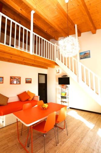 a living room with a red couch and a table at Cuore Della Valle in Cefalù