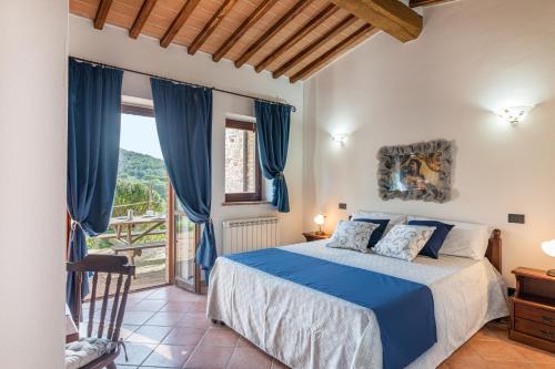 una camera da letto con letto e tende blu di AGRITURISMO PODERE TOSCANO a Città della Pieve