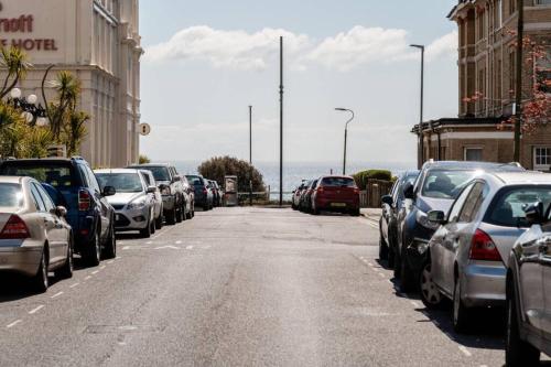 a street with cars parked on the side of the road at Rockmount Court in Bournemouth