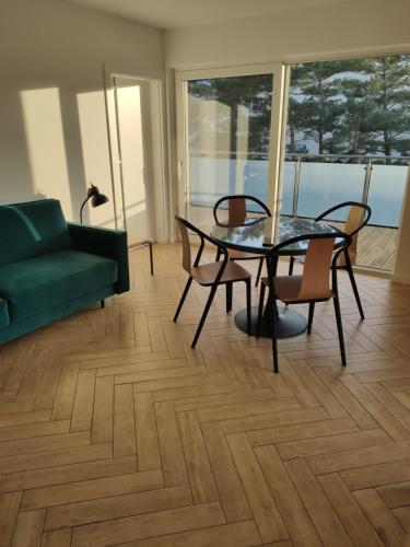 a living room with a table and chairs and a couch at GOLDEN SANDS in Rowy