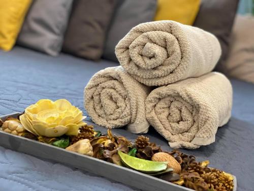 a tray of towels and nuts on a bed at Daylight City Center in Szeged
