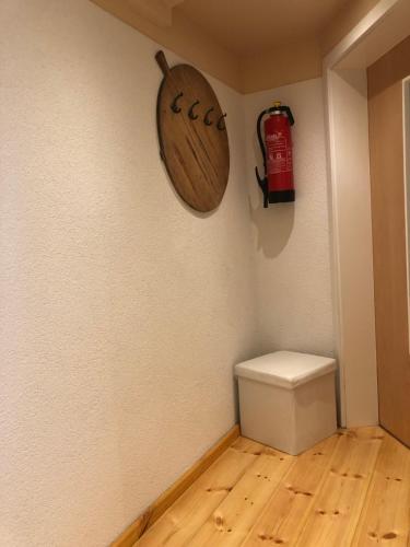 a bathroom with a toilet and a fire extinguisher on the wall at Ferienwohnung Alte Molkerei in Bad Sulza
