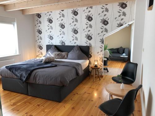 a bedroom with a bed and a table and chairs at Ferienwohnung Alte Molkerei in Bad Sulza