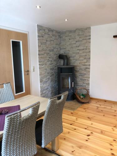 a living room with a table and a fireplace at Ferienwohnung Alte Molkerei in Bad Sulza