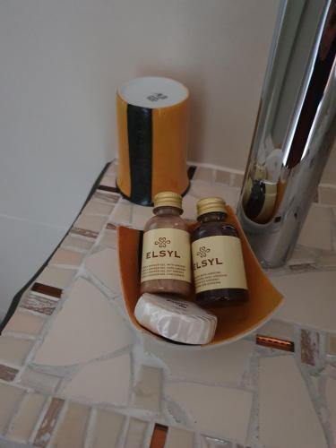 two bottles of essential oils sitting on a counter at Hôtel restaurant du Commerce in Poulainville