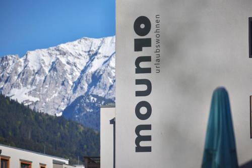 a sign for a hotel in front of a mountain at moun10 urlaubswohnen in Garmisch-Partenkirchen
