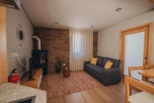 a living room with a couch and a television at Ti`Justina Country House in Rossas