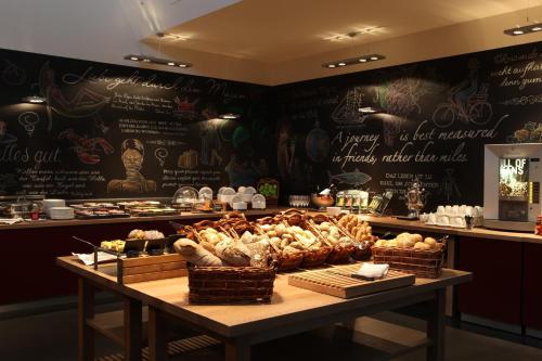 a bakery with a table with baskets of bread at pentahotel Wiesbaden in Wiesbaden