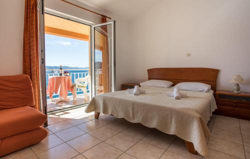a bedroom with a bed and a balcony with a view at Apartmani Nikoletić in Klek