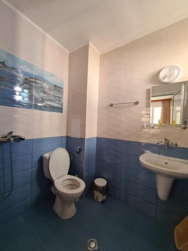 a bathroom with a toilet and a sink at Guest Rooms Kostovi in Nesebar