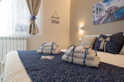 a bedroom with a bed with towels on it at Appartamento Antonacci in Monopoli