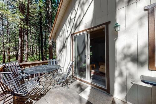a patio with a table and chairs on a porch at Snowpeak Chalet in Camp Connell