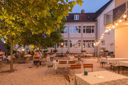 a group of tables and chairs in front of a building at Gasthof Diem in Krumbach